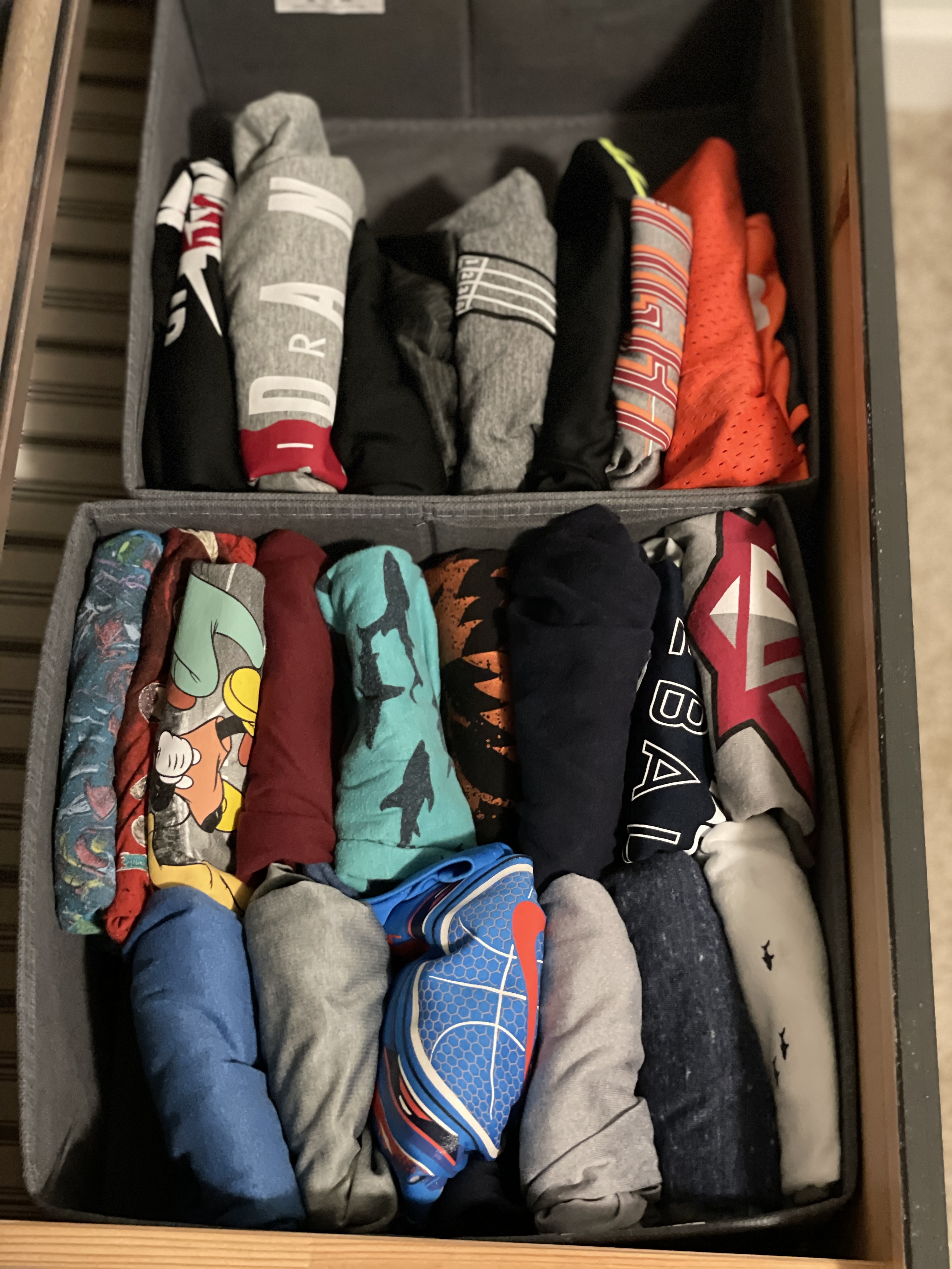 Kids clothes organized in a dresser drawer 