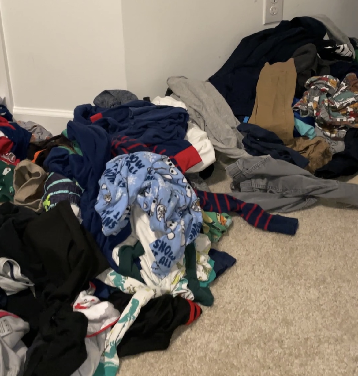 Messy kids clothes on the floor needing organized 