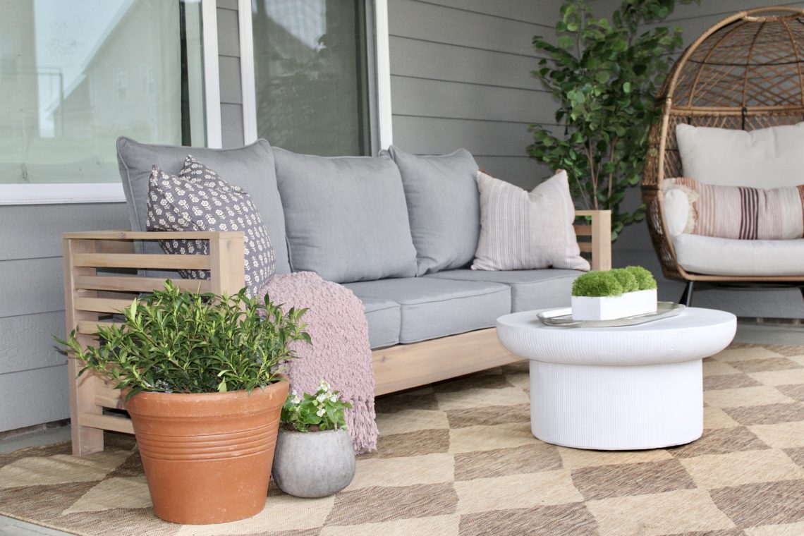 DIY outdoor Sofa on patio with gray cushions and checkered rug