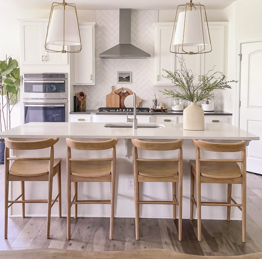 Target overstock warehouse stools in white kitchen with pendant lights