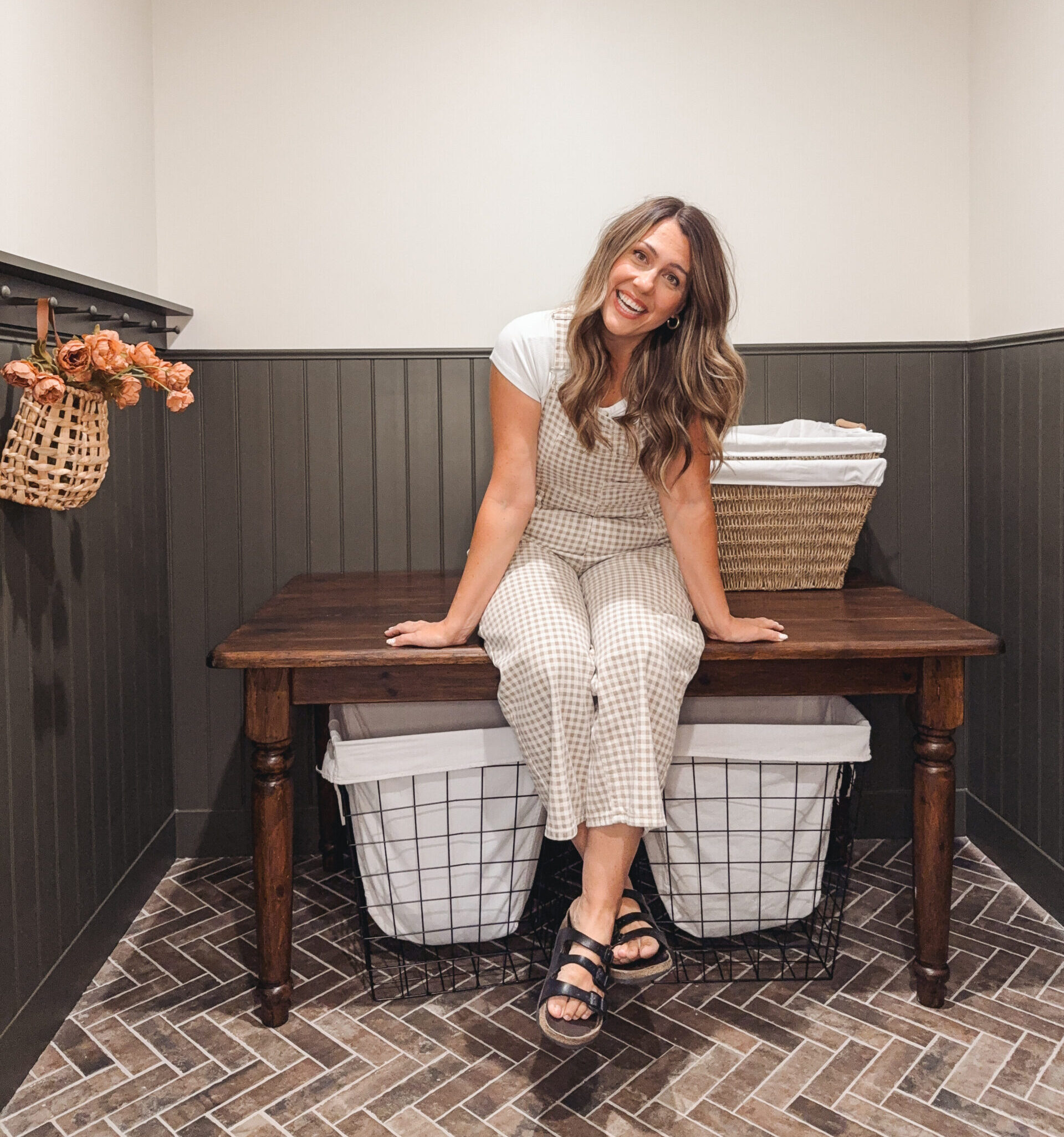 diy mom sitting on a vintage farmhouse table with turned legs that was refinished